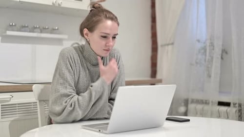 Woman Works at Laptop in Bright Kitchen