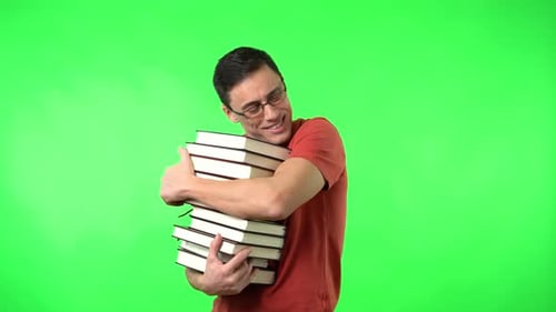 Man Hugging Books Against a Green Background