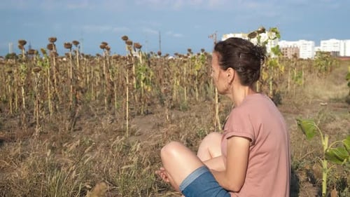 Female Look Sad at Dry Field