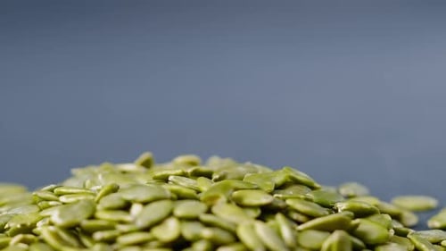 Closeup on Blackblue Background Lie Green Pumpkin Peeled Seeds Healthy Eating Autumn Harvest Healthy
