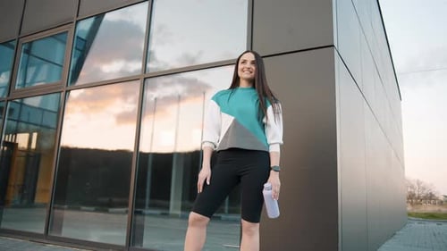 Woman in Athletic Clothes Standing Outside