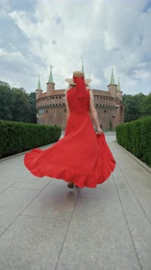 Blond Woman in Red Dress Walking to Castle