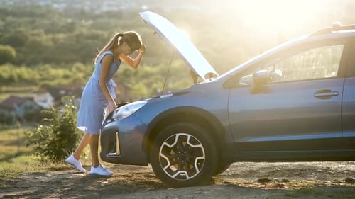 Young Woman Driver Standing Near a Broken Car with Open Hood Having Trouble with Her Vehicle