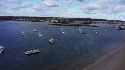 Lobster fishing boats with traps and equipment in coastal maine harbor, Aerial