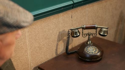 Man Answers a Vintage Candlestick Telephone