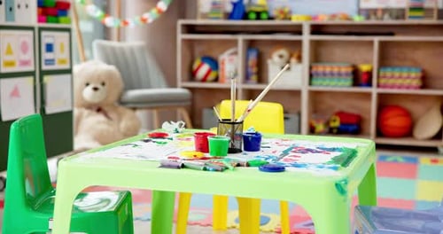 Colorful Art Supplies on Table in Bright Playroom