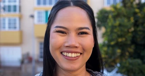 Smiling Woman Posing for Camera Outdoors