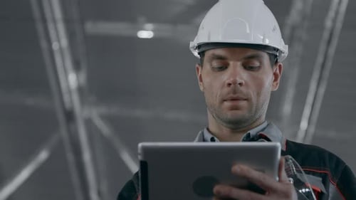 Engineer Plan of Machinery Manufacture Work. Caucasian People in Hard Hat Or