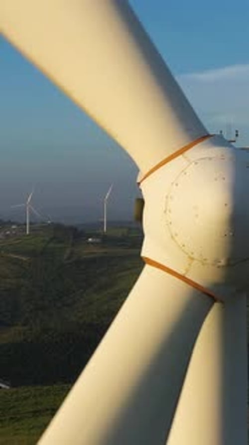 Wind Turbine with Blades in Green Rural Area on Sunny Day Aerial View Vertical Video