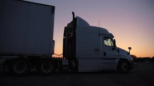 Semi-Truck Parked During a Vibrant Sunset