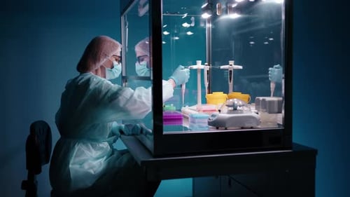 Scientist Performs Research in Medical Laboratory Enclosure