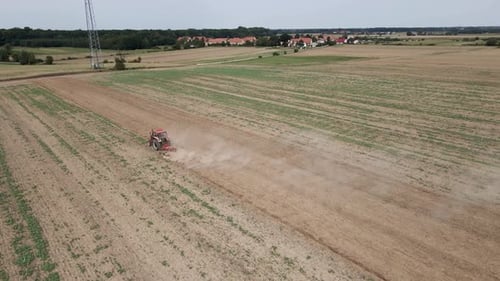Small Tractor Cultivating Soil at Agricultural Field Aerial View