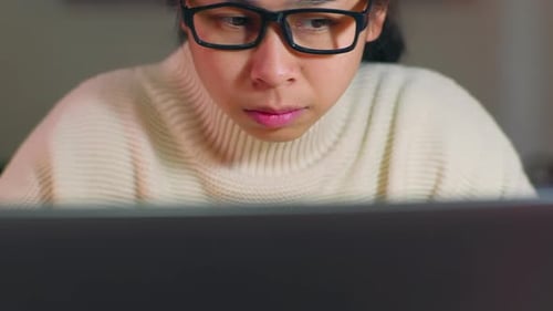 Young Adult Working on Laptop at Home