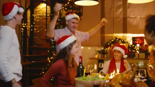 Family Celebrates Christmas Dinner and Dances Together