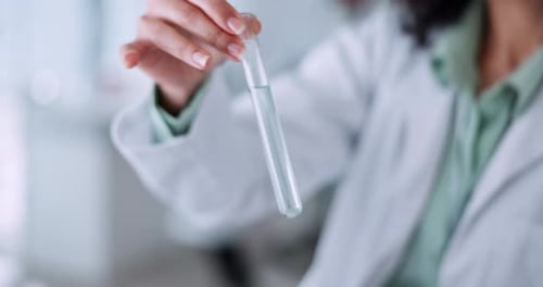 Woman Scientist Examining Test Tube in Lab