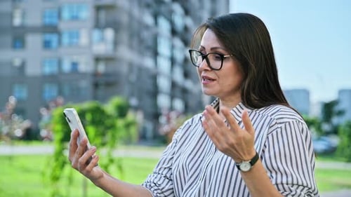 Middle Aged Woman Talking on Video Call Using Smartphone Urban Outdoor City