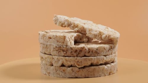 Rotating Rice waffles on a beige background.