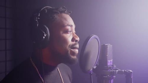 Black Pop Singer is Performing Song in Professional Recording Studio Portrait of Talented Musician