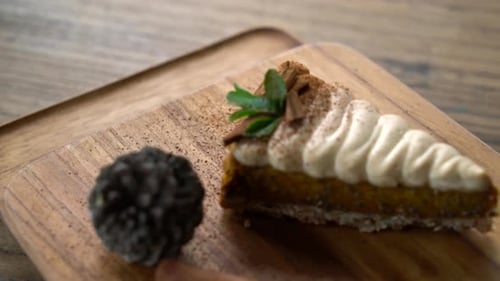 Pumpkin Pie with Cream and Cinnamon on Plate