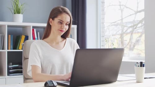 Young Woman Works at Home Office Using Computer Workplace of Female Entrepreneur Freelancer or