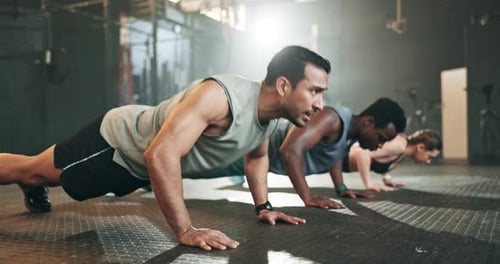 Gym, group fitness and push up exercise for power, sports challenge and muscle on ground