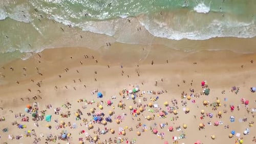 Summertime in a public Beach with colorful umbrellas
