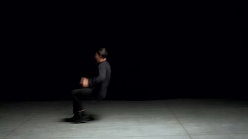 Male Dancer Performs Modern Routine in Dark Room