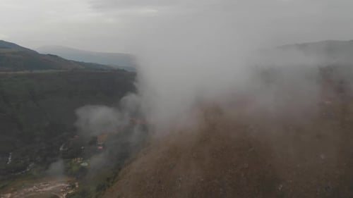 Pull front across fog above hillside