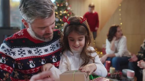 Festive Father and Child Opening Christmas Gifts