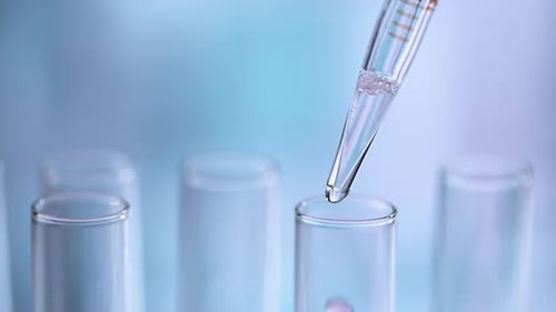 Liquid Being Dropped from Pipette into Test Tube