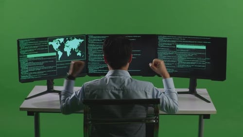Happy Asian Man Celebrating While Write Code With Multiple Computer Screens In Green Screen