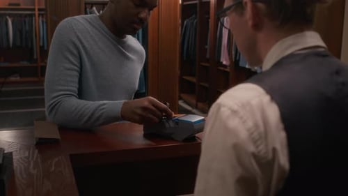 Black Customer Paying by Card for Purchase in Mens Clothing Store