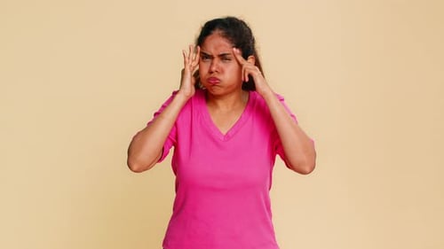 Distressed Woman Expressing Headache with Hands on Head