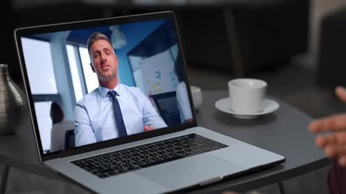 Two Businessmen Distance Meeting Using Laptop in Cafe Closeup Remote Conference