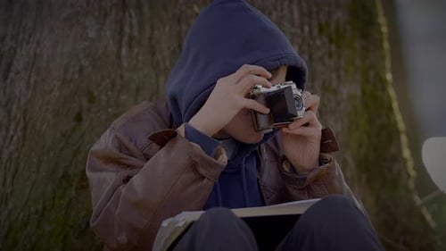 Young Adult Takes Photos with a Vintage Camera
