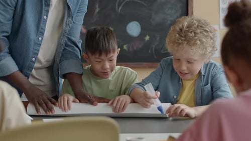 Little Classmates Making Paper Craft Together at School