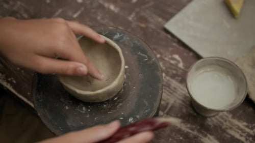 Unrecognizable Person Smoothing Clay Mug at Studio