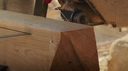 Saw Blade Cutting a Wooden Block Close Up