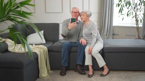 Senior Couple Posing for Selfie on Couch