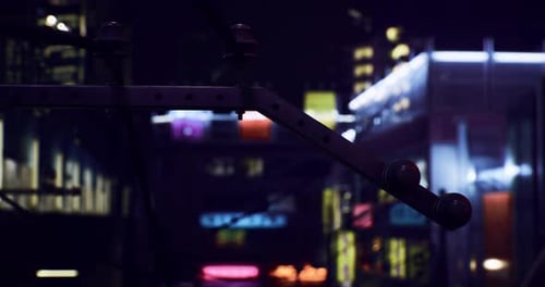Vibrant Neon Lights and Urban Architecture Brighten City Streets at Night