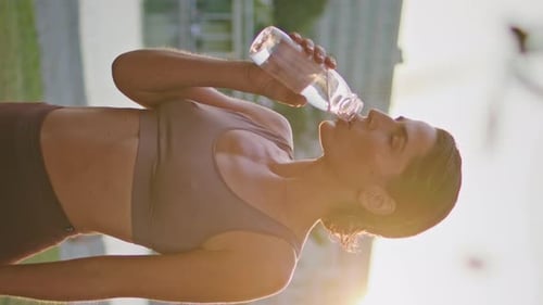 Thirsty Woman Drink Water in Park Vertical Closeup Runner Resting Workout Break