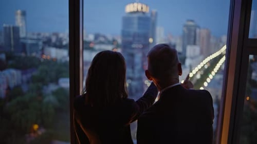 Silhouettes Two Business People Looking Night Cityscape From Office Closeup