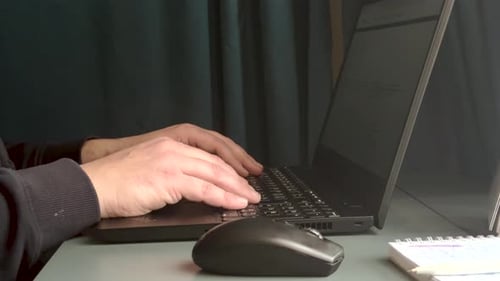 Man typing on laptop keyboard working in home. Freelancer works on a laptop, close - up .Type A.