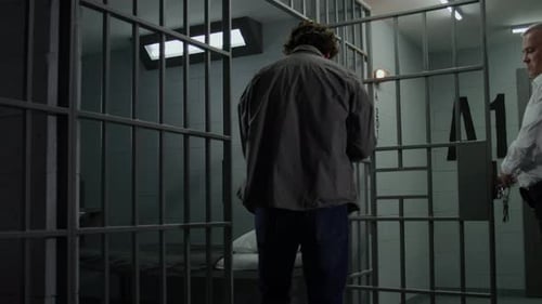 Depressed Prisoner Goes Inside Jail Cell and Sits Down on Bed