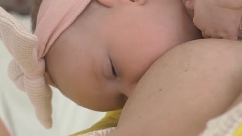 Close Up of Breastfeeding Infant in Intimate Scene
