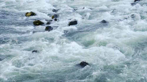 Pure Water Stream Running Through Stone Boulders