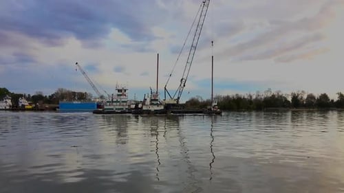 Tug and dredging equipment floating down the Savanna River