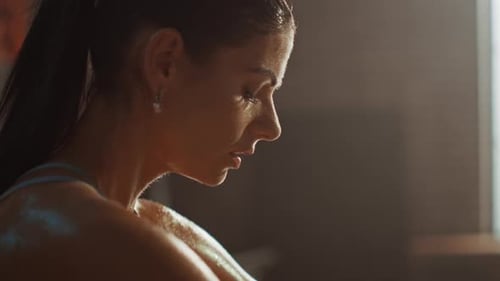 Beautiful Strong Fit Brunette in Sport Top and Shorts in a Loft Industrial Gym with Motivational Po