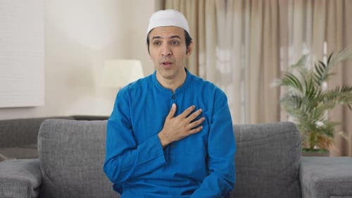 Adult Coughing and Touching his Chest at Home