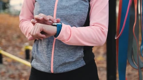Woman Checking Smartwatch During Outdoor Workout